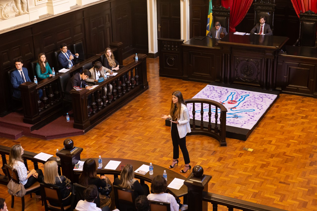 Alunos participam de júri simulado no Antigo Tribunal do Júri. No centro da imagem, uma estudante fala aos "jurados"