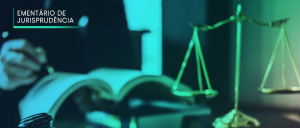 EMENTÁRIO DE JURISPRUDÊNCIA” no canto superior esquerdo. Imagem desfocada em verde-azul, apresentando, à direita, à frente, uma estatueta da balança da Justiça, e à esquerda, ao fundo, mão de homem manuscrevendo, de caneta, na página direita de um livro aberto, estando este livro sobre outro, também aberto.